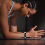 Person using Xiaomi Smart Band 10 Ceramic Edition during gym workout fitness tracking